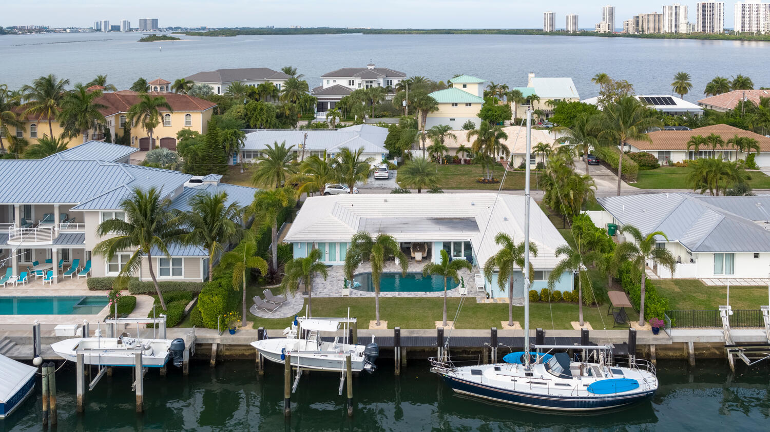 1041 Gulfstream Way Riviera Beach, FL 33404 - Photo 15 of 39 a view of a patio with lawn chairs under an umbrella
