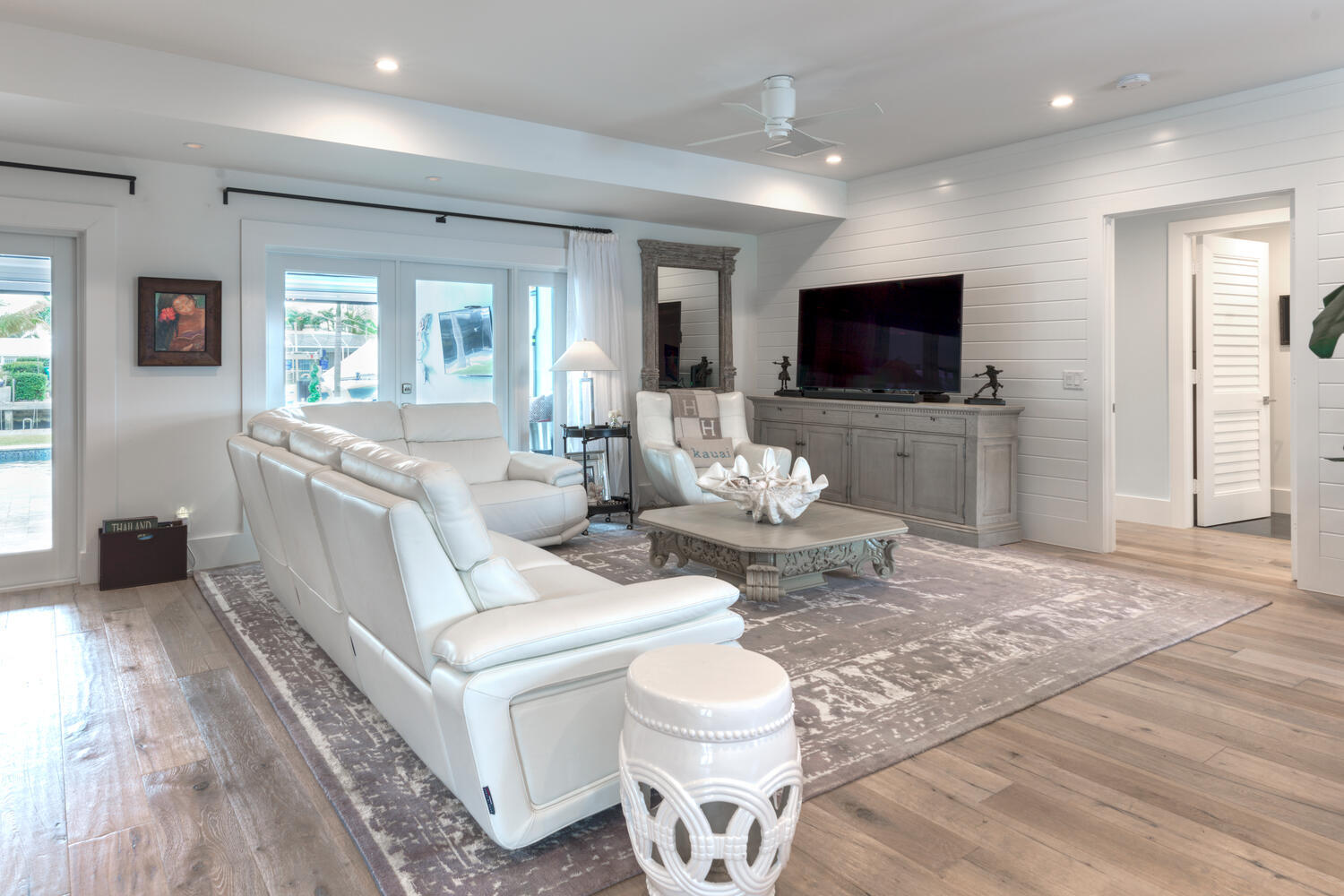 1041 Gulfstream Way Riviera Beach, FL 33404 - Photo 23 of 39 a living room with furniture a flat screen tv and a large window
