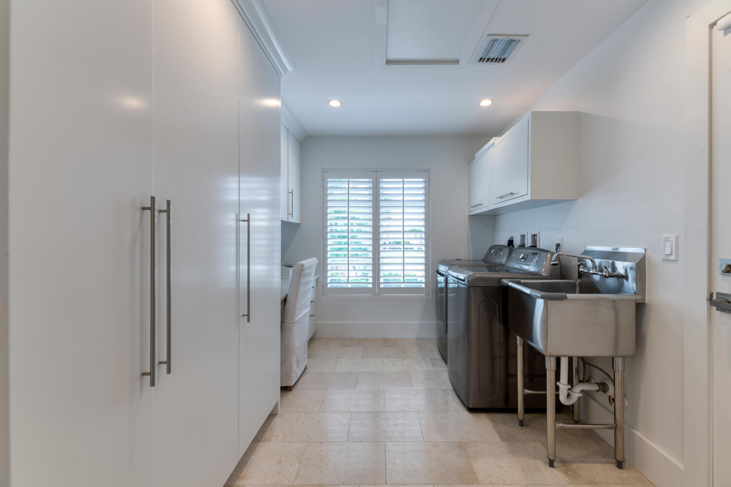 1041 Gulfstream Way Riviera Beach, FL 33404 - Photo 24 of 39 a kitchen with refrigerator and cabinets