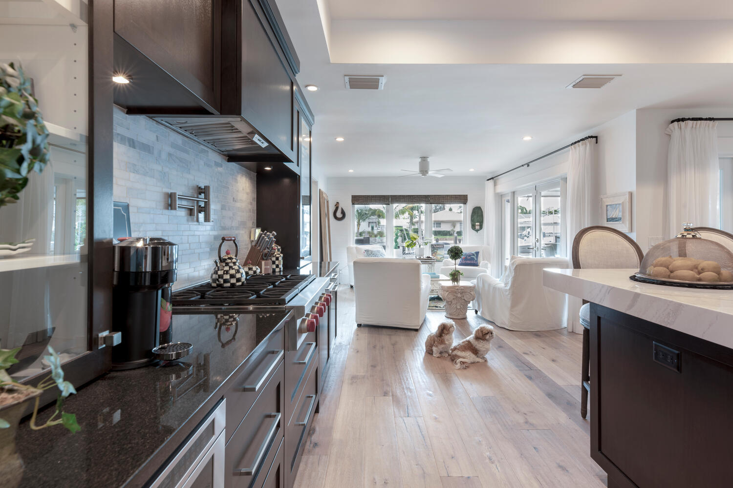 1041 Gulfstream Way Riviera Beach, FL 33404 - Photo 25 of 39 a kitchen that has a lot of cabinets stainless steel appliances and a wooden floor