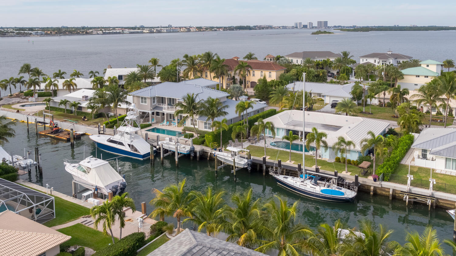 1041 Gulfstream Way Riviera Beach, FL 33404 - Photo 3 of 39 a view of a lake with houses