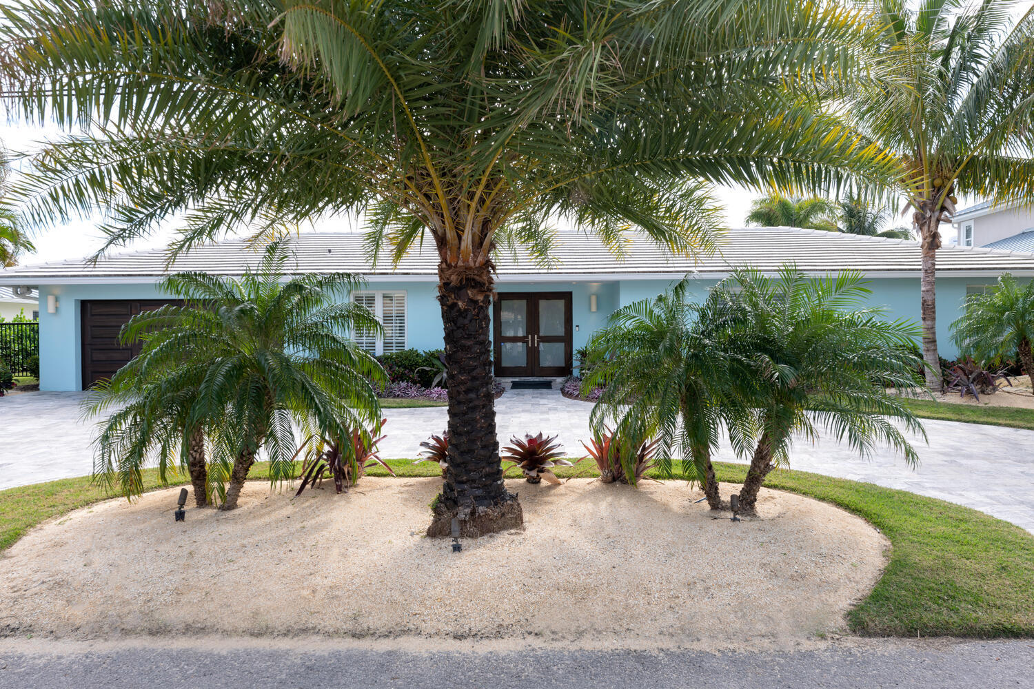 1041 Gulfstream Way Riviera Beach, FL 33404 - Photo 32 of 39 a palm tree sitting in front of a house with palm trees