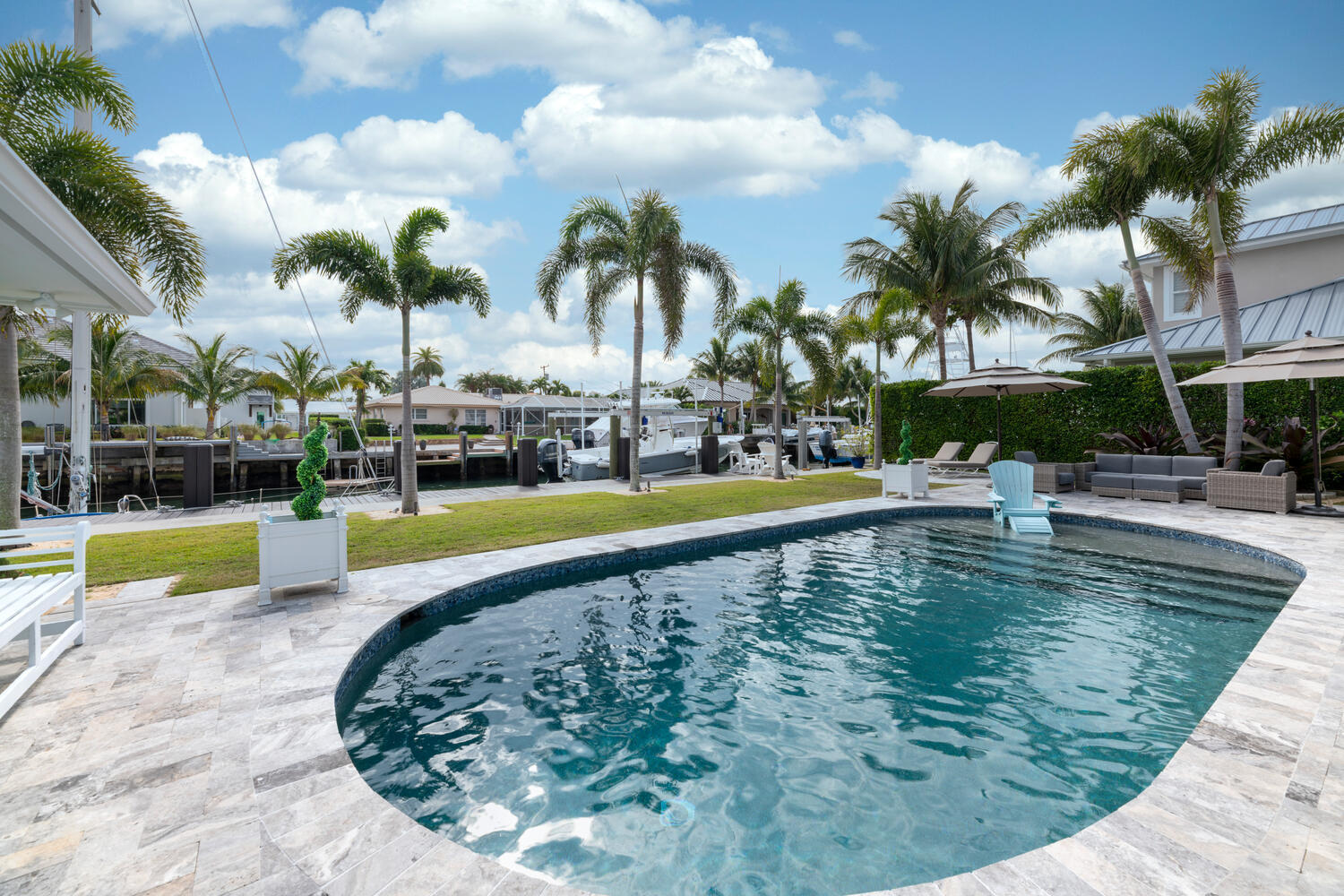1041 Gulfstream Way Riviera Beach, FL 33404 - Photo 9 of 39 a view of swimming pool with a garden and seating area