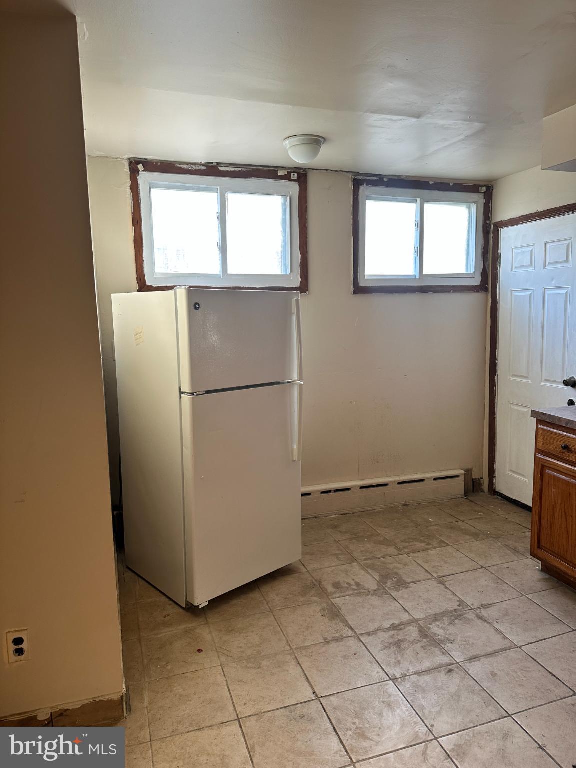 1508 West Nedro Avenue Philadelphia, PA 19141 - Photo 6 of 20 a view of a kitchen with a refrigerator cabinets and a window