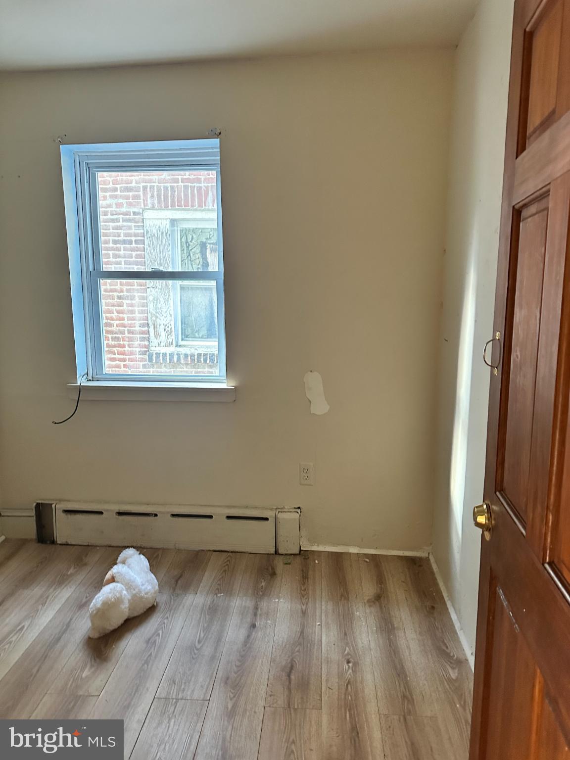1508 West Nedro Avenue Philadelphia, PA 19141 - Photo 8 of 20 an empty room with wooden floor and windows