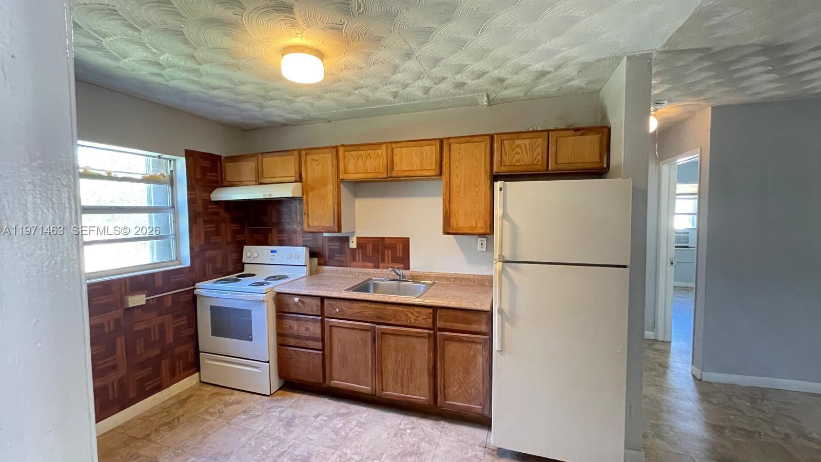 2908 Dunbar Street Fort Pierce, FL 34947 - Photo 6 of 10 a kitchen with a sink appliances and cabinets