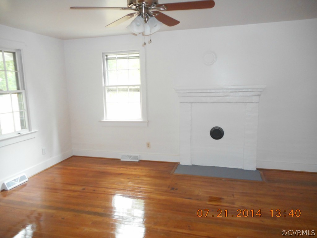 2468 Cumberland Road Farmville, VA 23901 - Photo 8 of 22 a view of a livingroom with an empty space a ceiling fan and window