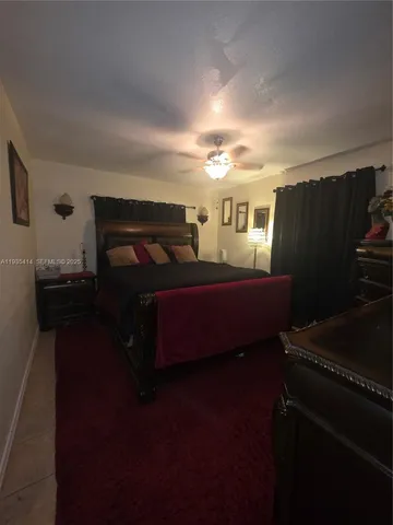 a bedroom with furniture and a mirror