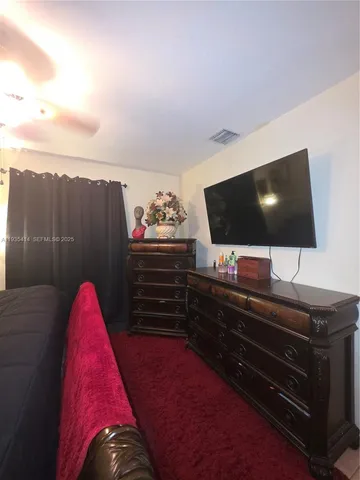 a living room with a flat screen tv and a fireplace