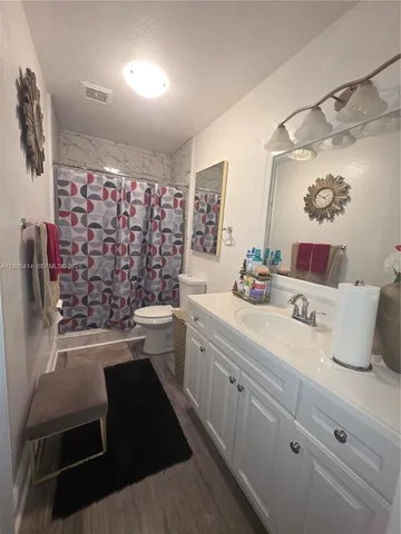a bathroom with a double vanity sink toilet and shower