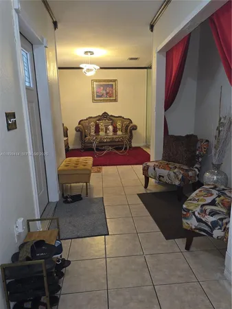 a living room with furniture and a mirror