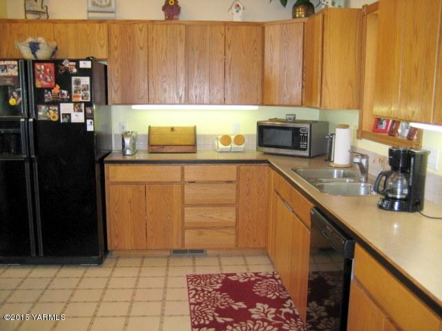 8810 Robillard Road Moxee, WA 98936 - Photo 9 of 29 a kitchen with a sink cabinets and appliances