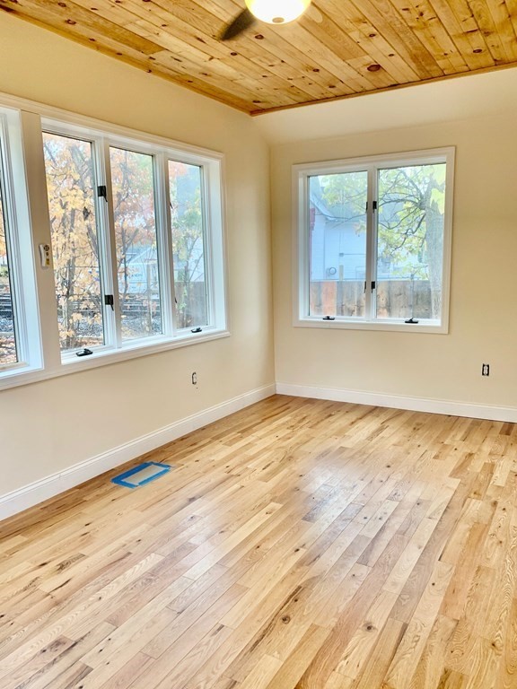 7 Center Road Shirley, MA 01464 - Photo 8 of 28 a view of an empty room with wooden floor and a window