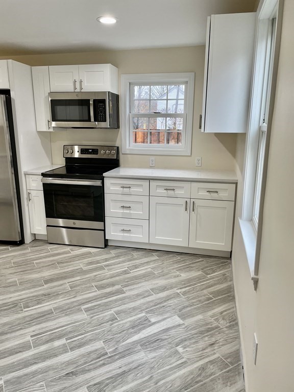 7 Center Road Shirley, MA 01464 - Photo 10 of 28 a kitchen with granite countertop a stove microwave and sink
