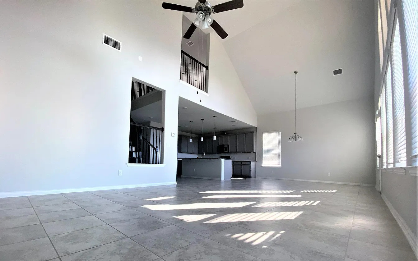 717 Paper Daisy Path Leander, TX 78641 - Photo 7 of 7 A spacious great room featuring high ceilings and a versatile open floorplan for modern living.