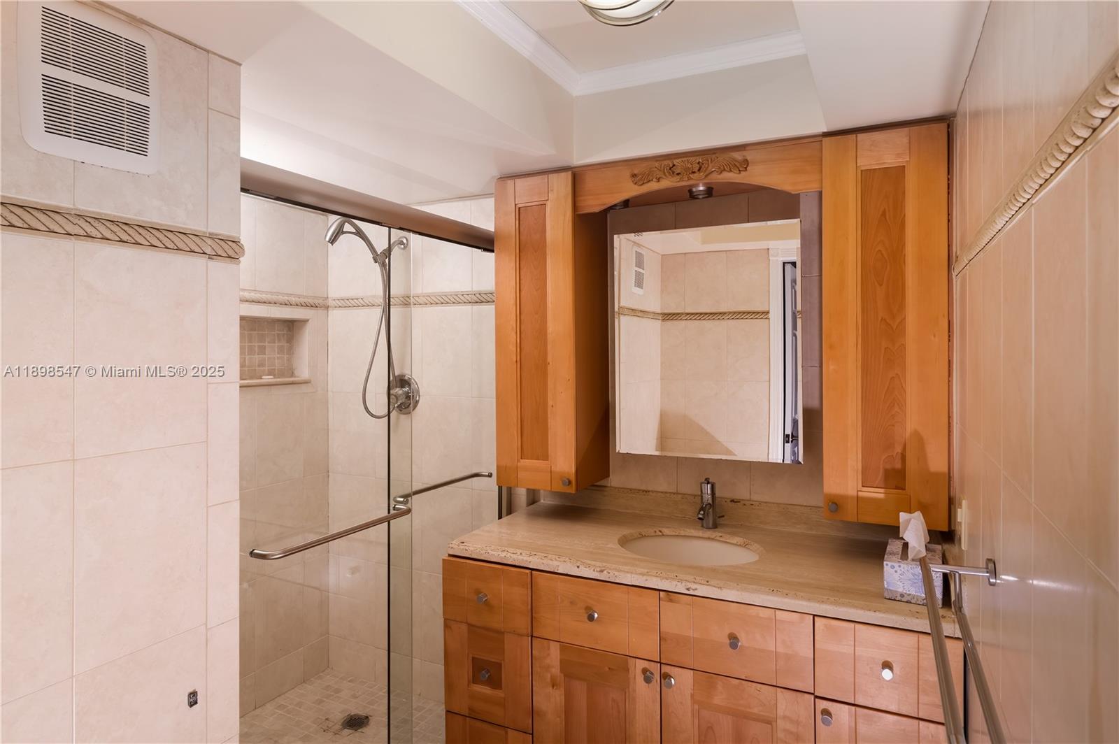 16200 Golf Club Road, Unit 312 Weston, FL 33326 - Photo 12 of 21 a bathroom with a granite countertop sink mirror and a shower
