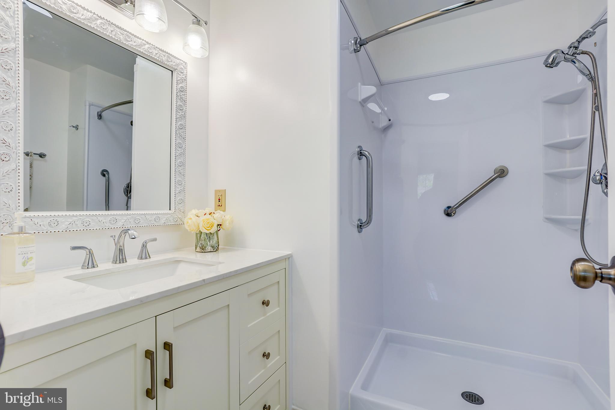 614 Suffield Drive Gaithersburg, MD 20878 - Photo 12 of 22 a bathroom with a sink vanity tub and shower