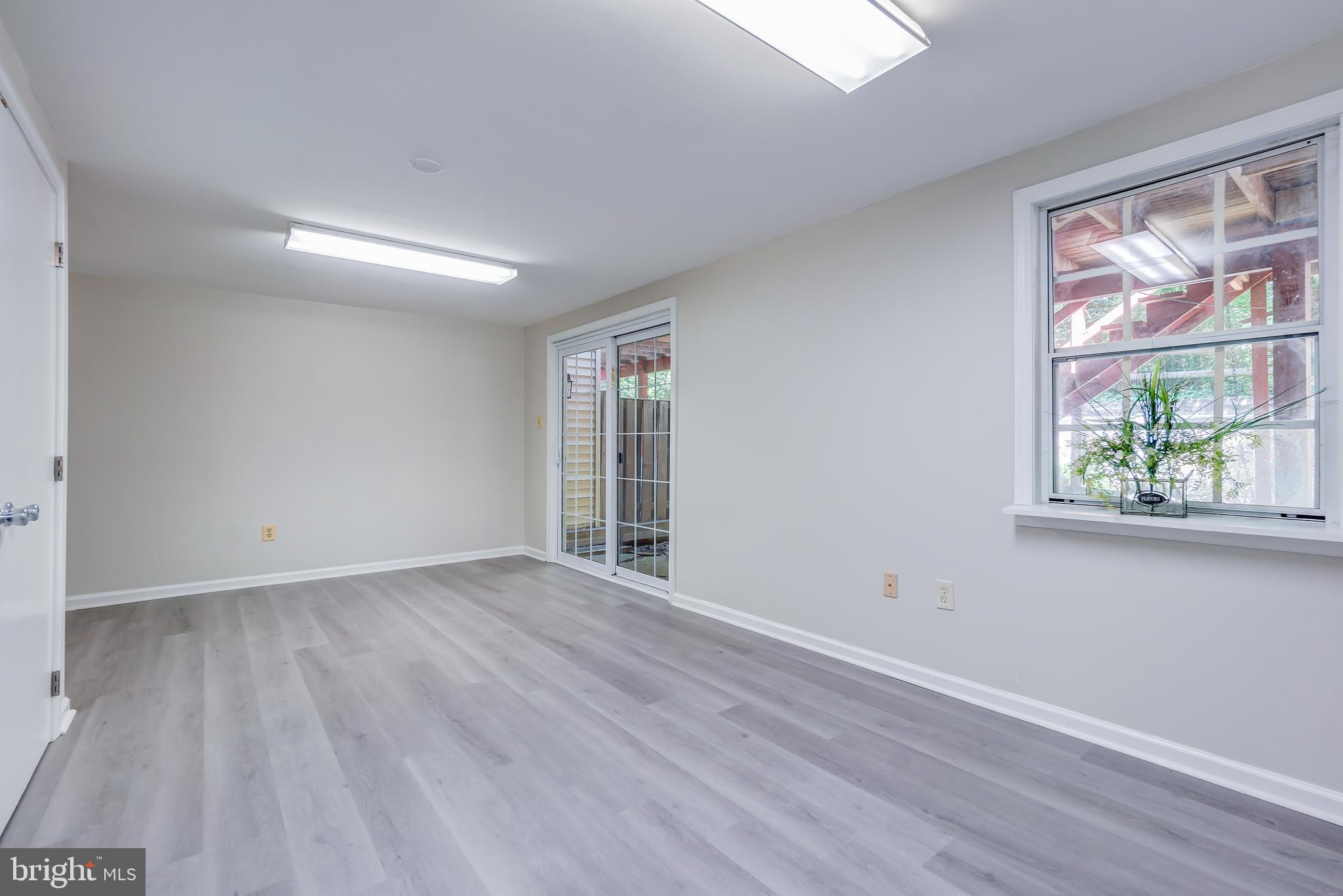 614 Suffield Drive Gaithersburg, MD 20878 - Photo 17 of 22 an empty room with wooden floor and windows