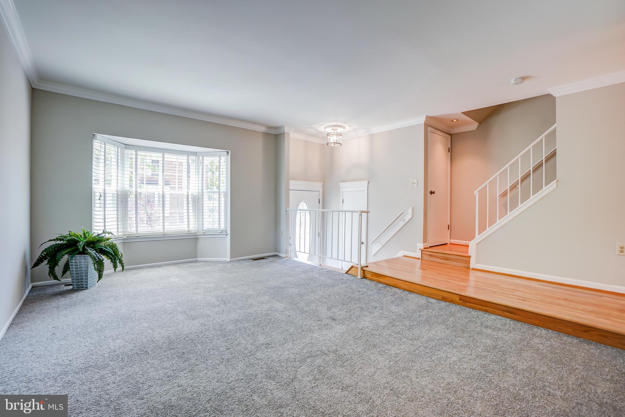 614 Suffield Drive Gaithersburg, MD 20878 - Photo 3 of 22 an empty room with windows and stairs