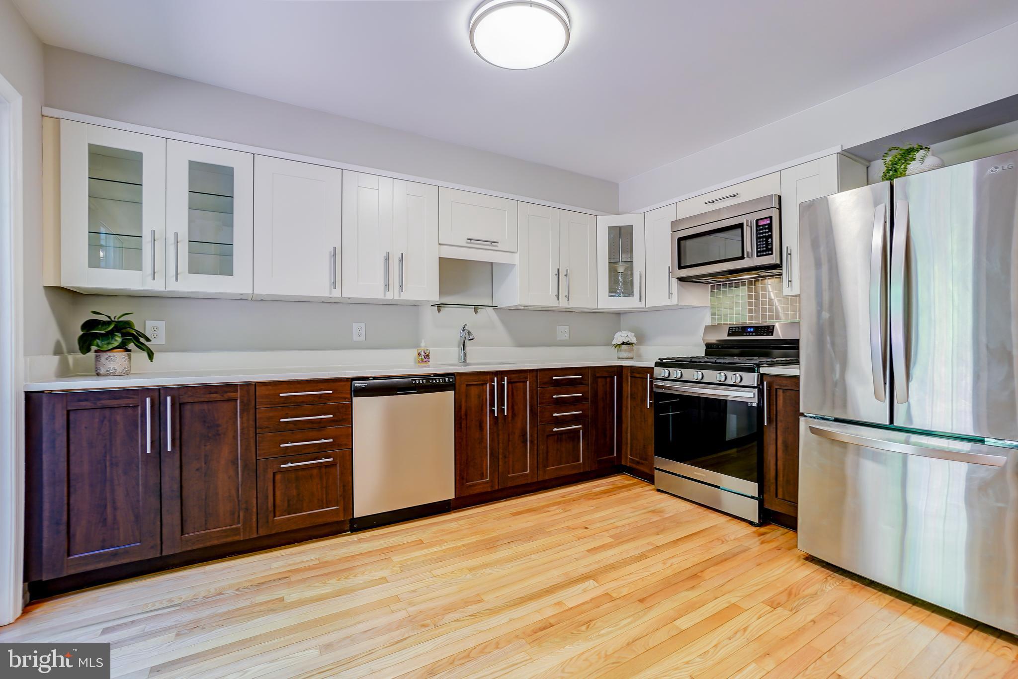 614 Suffield Drive Gaithersburg, MD 20878 - Photo 5 of 22 a kitchen with granite countertop stainless steel appliances and wooden cabinets