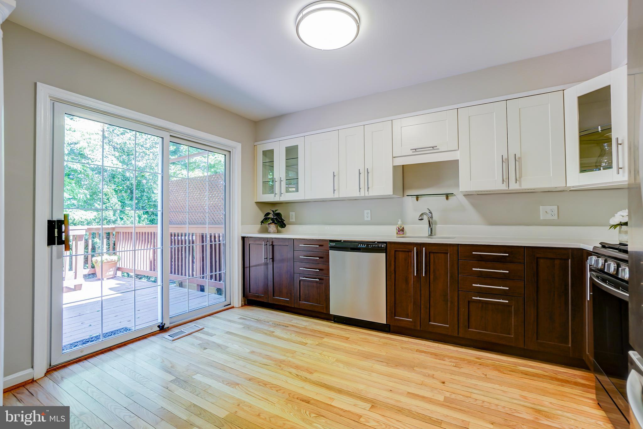 614 Suffield Drive Gaithersburg, MD 20878 - Photo 6 of 22 a kitchen with stainless steel appliances granite countertop a stove a sink and a refrigerator with wooden floors