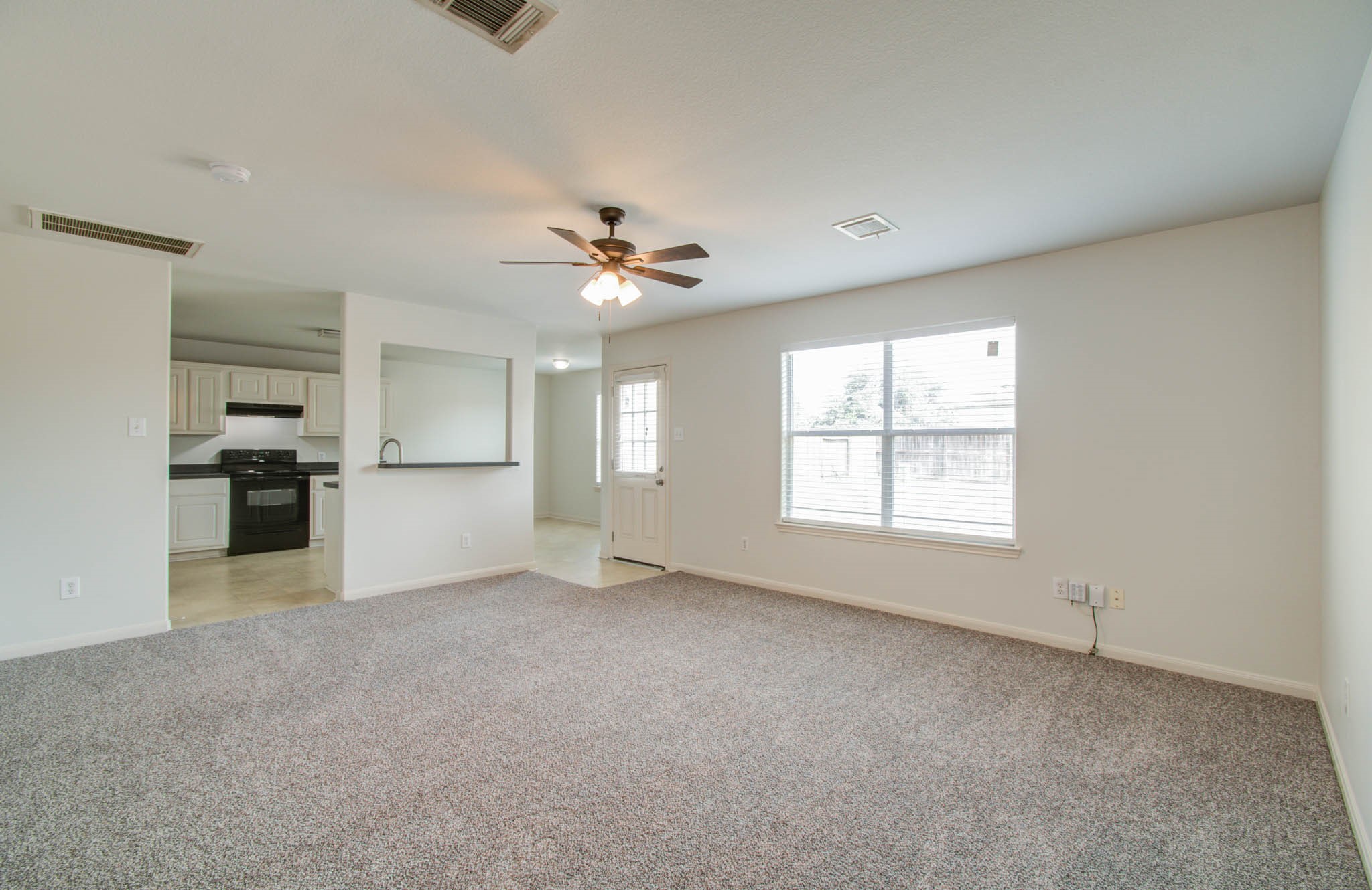 4239 Nueces River Loop Spring, TX 77386 - Photo 12 of 50 a view of an empty room with a kitchen