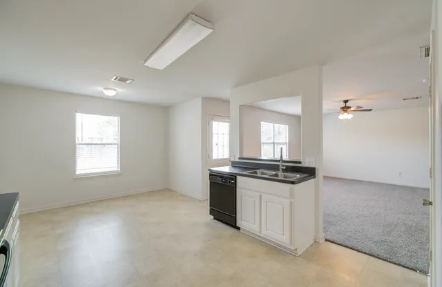 a kitchen with granite countertop a stove and a sink