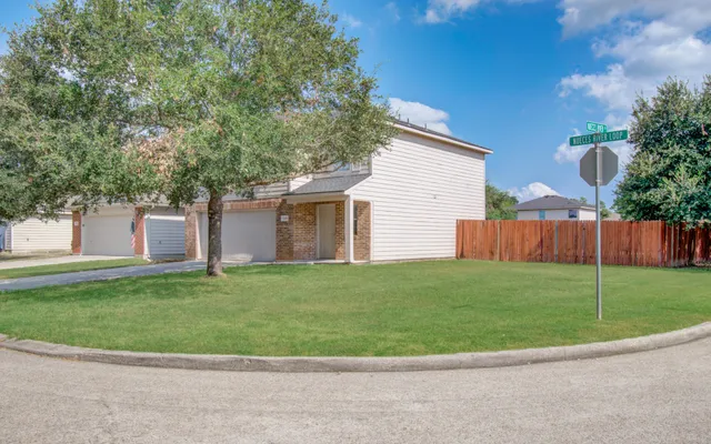 a view of a house with a backyard