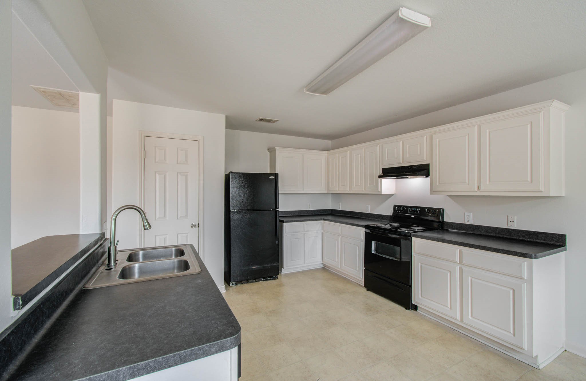 4239 Nueces River Loop Spring, TX 77386 - Photo 21 of 50 a kitchen with granite countertop a refrigerator stove and sink