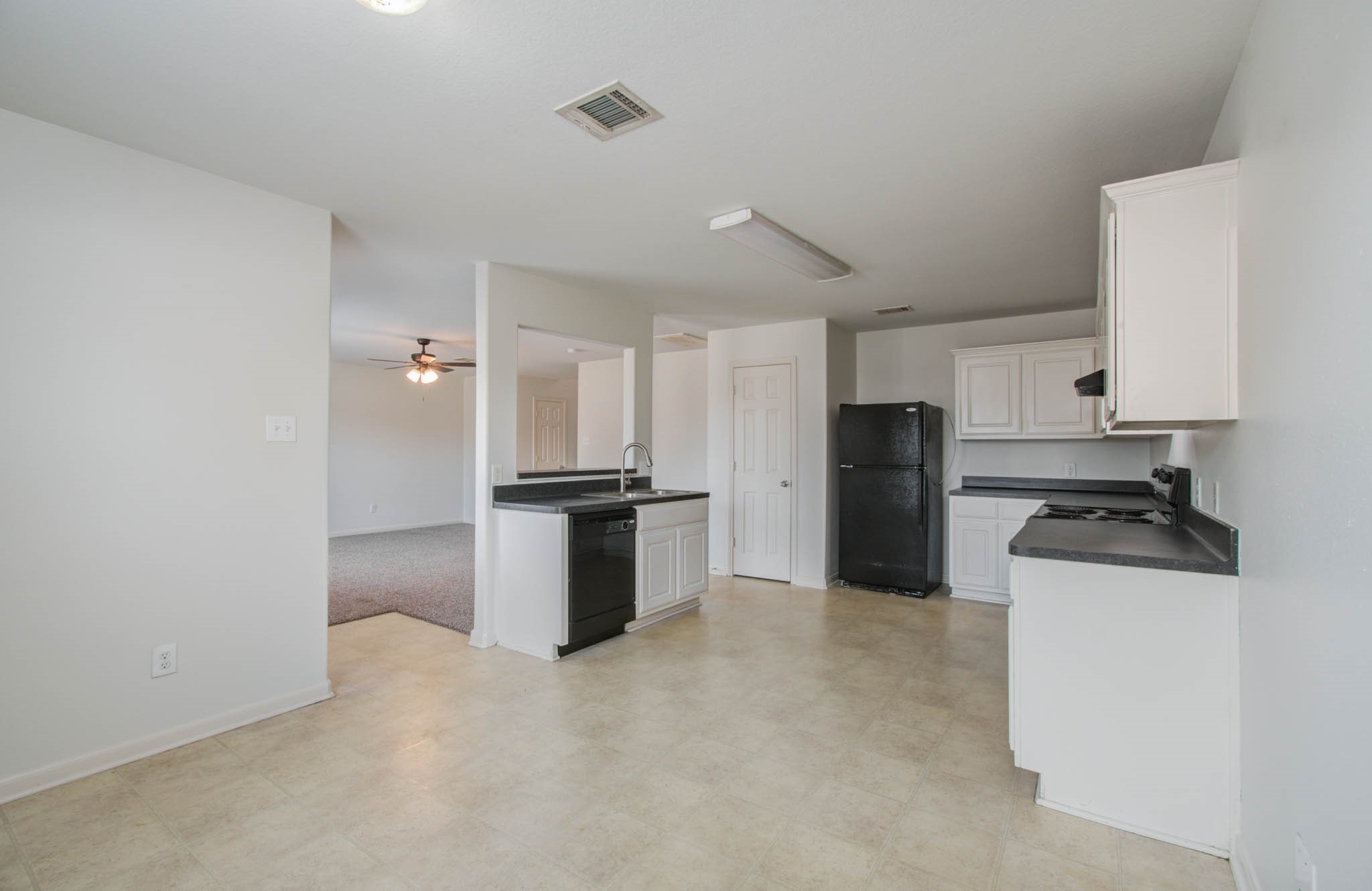 4239 Nueces River Loop Spring, TX 77386 - Photo 26 of 50 a kitchen with stainless steel appliances a refrigerator and a stove top oven