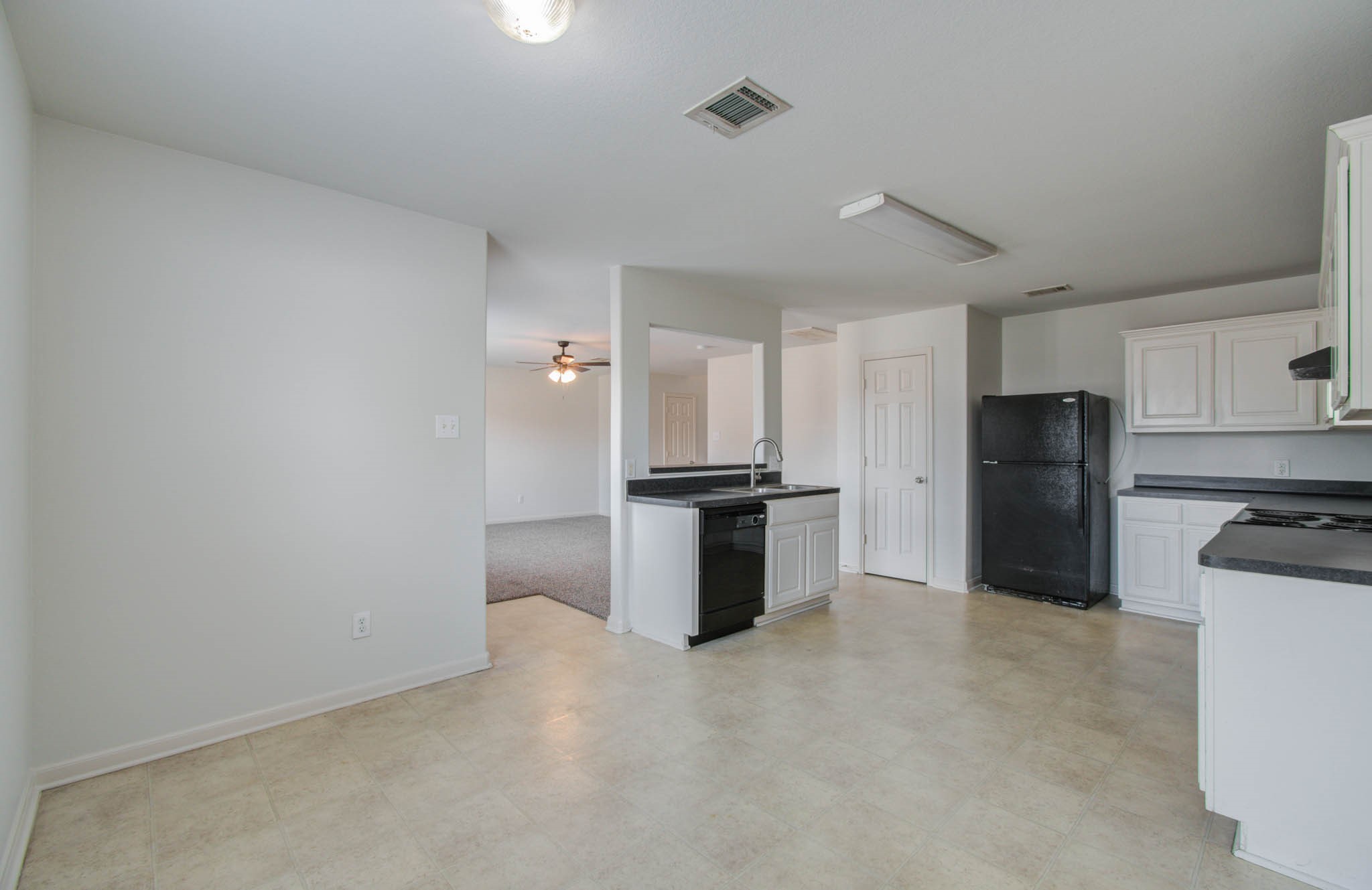4239 Nueces River Loop Spring, TX 77386 - Photo 27 of 50 a kitchen with granite countertop a refrigerator and a stove