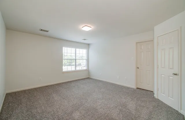 a view of an empty room and a bathroom