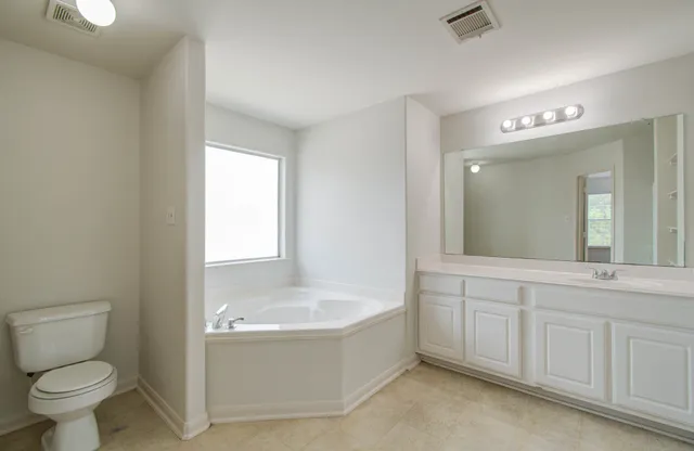 a spacious bathroom with a shower and a sink