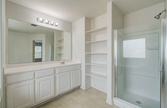 a bathroom with a bathtub a sink and a window
