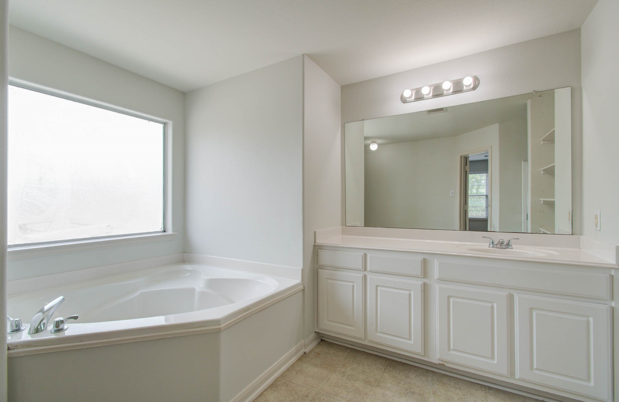 4239 Nueces River Loop Spring, TX 77386 - Photo 44 of 50 a bathroom with a bathtub a sink and a window