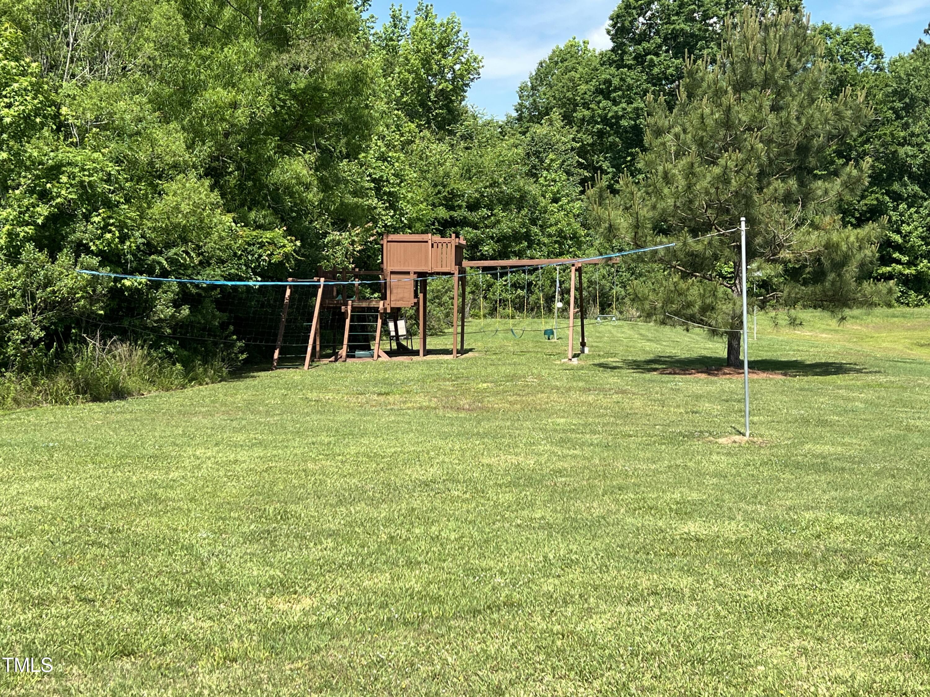 684 Lake Magnolia Way Smithfield, NC 27577 - Photo 18 of 19 a backyard of a house with lots of plants and space