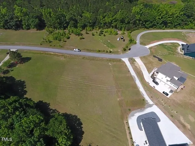 an aerial view of a house with yard