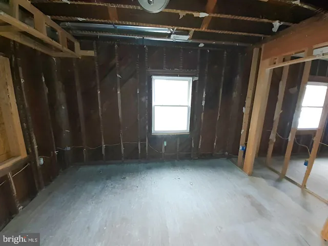 a view of a hallway with wooden floor and door