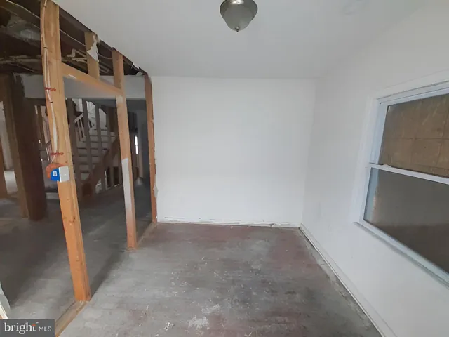 a view of a hallway with wooden floors and stairs