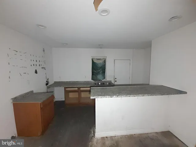 a view of a livingroom with wooden floor and a window