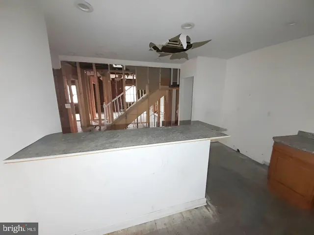 a view of a room with wooden floor and white walls