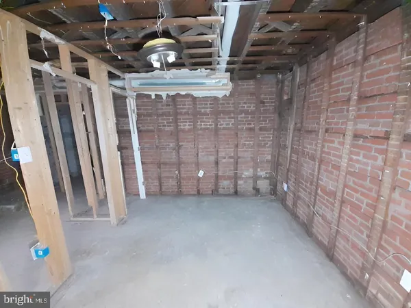 a view of an empty room with wooden floor and stairs