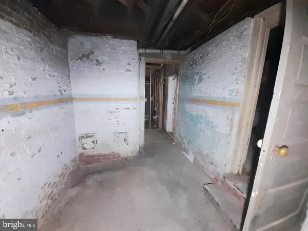 a view of a hallway with wooden floor and entryway