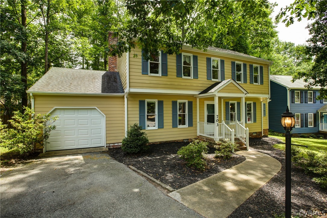 703 Fennimore Road Midlothian, VA 23114 - Photo 1 of 22 a front view of a house with garden