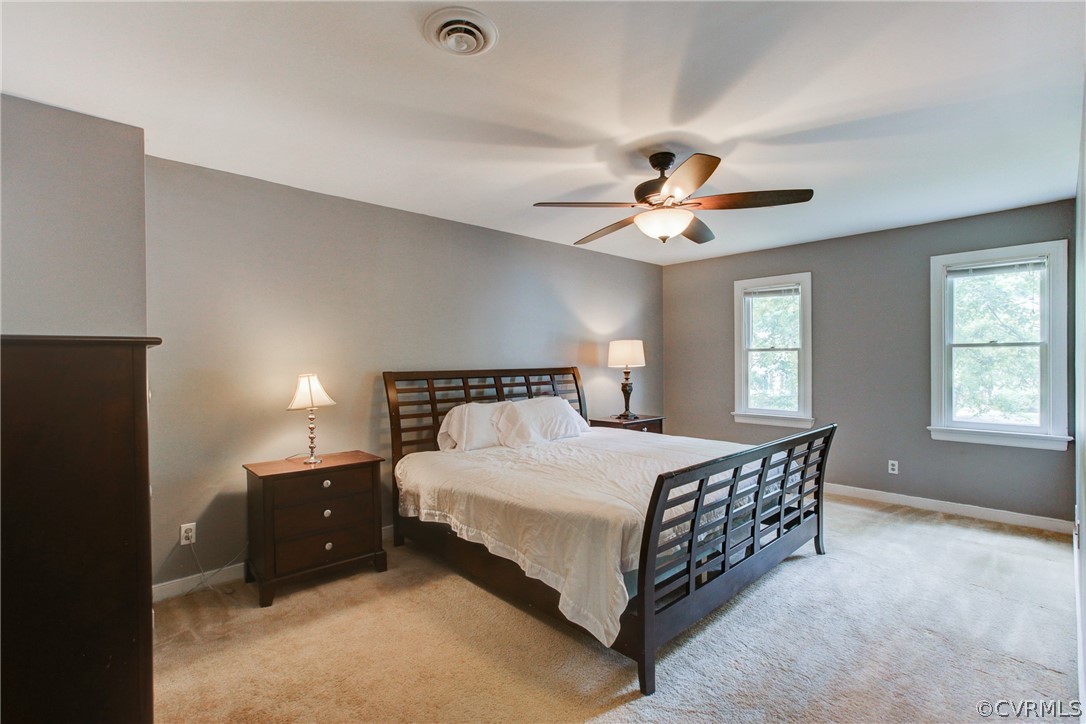703 Fennimore Road Midlothian, VA 23114 - Photo 11 of 22 a spacious bedroom with a bed and a ceiling fan