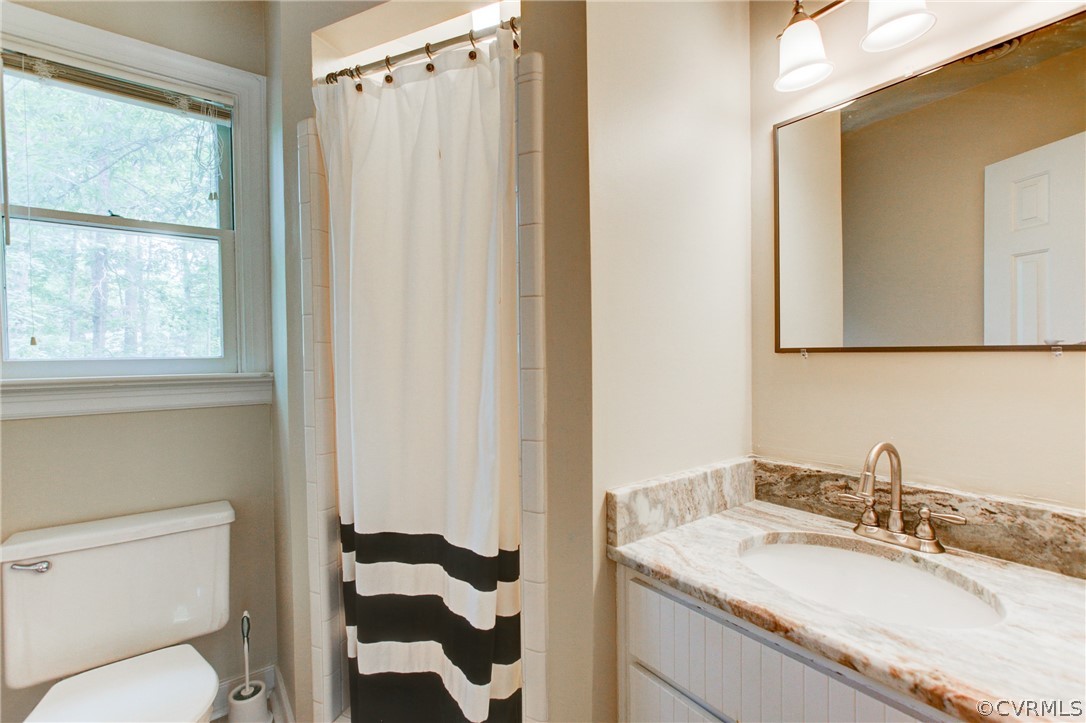703 Fennimore Road Midlothian, VA 23114 - Photo 13 of 22 a bathroom with a granite countertop sink toilet and shower