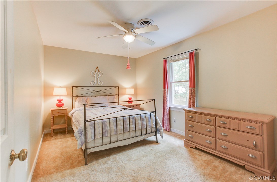 703 Fennimore Road Midlothian, VA 23114 - Photo 14 of 22 a view of a bedroom with a baby crib dresser and a window