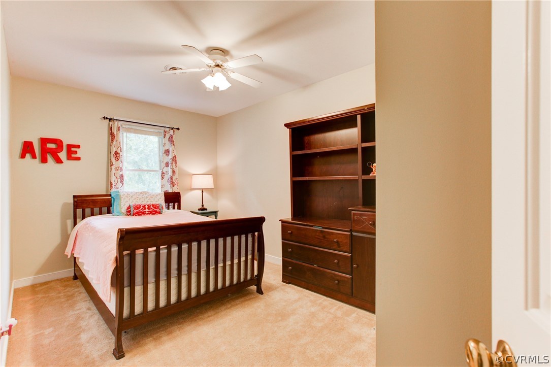 703 Fennimore Road Midlothian, VA 23114 - Photo 16 of 22 a bedroom with a bed and a chandelier