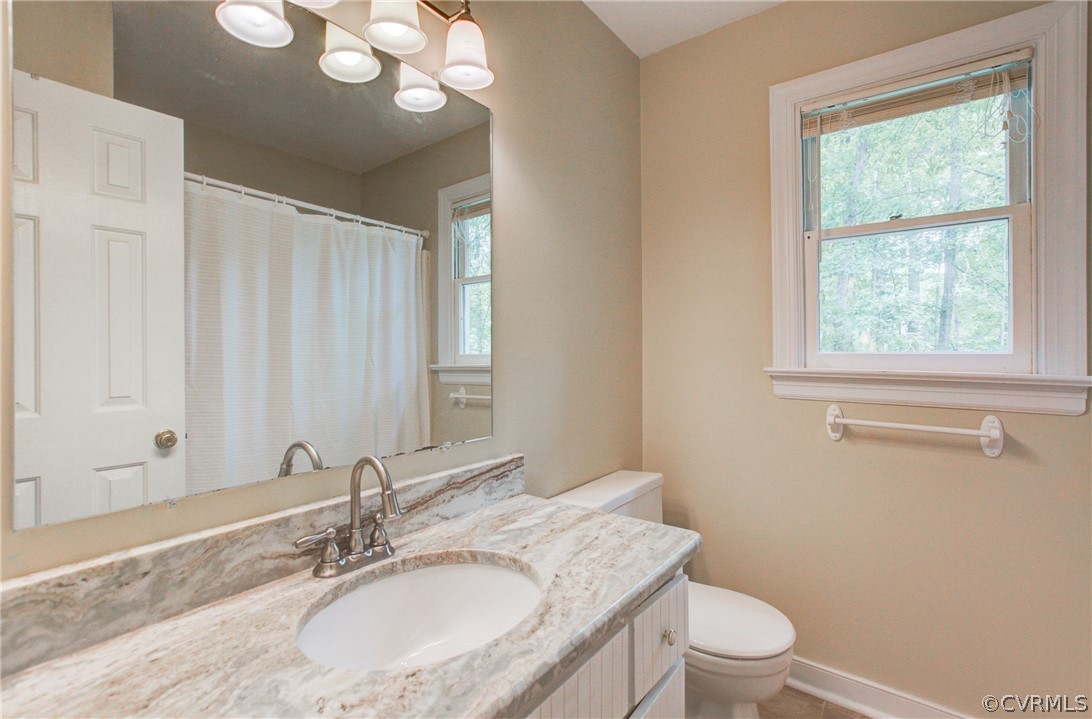 703 Fennimore Road Midlothian, VA 23114 - Photo 17 of 22 a bathroom with a granite countertop sink a toilet and a mirror