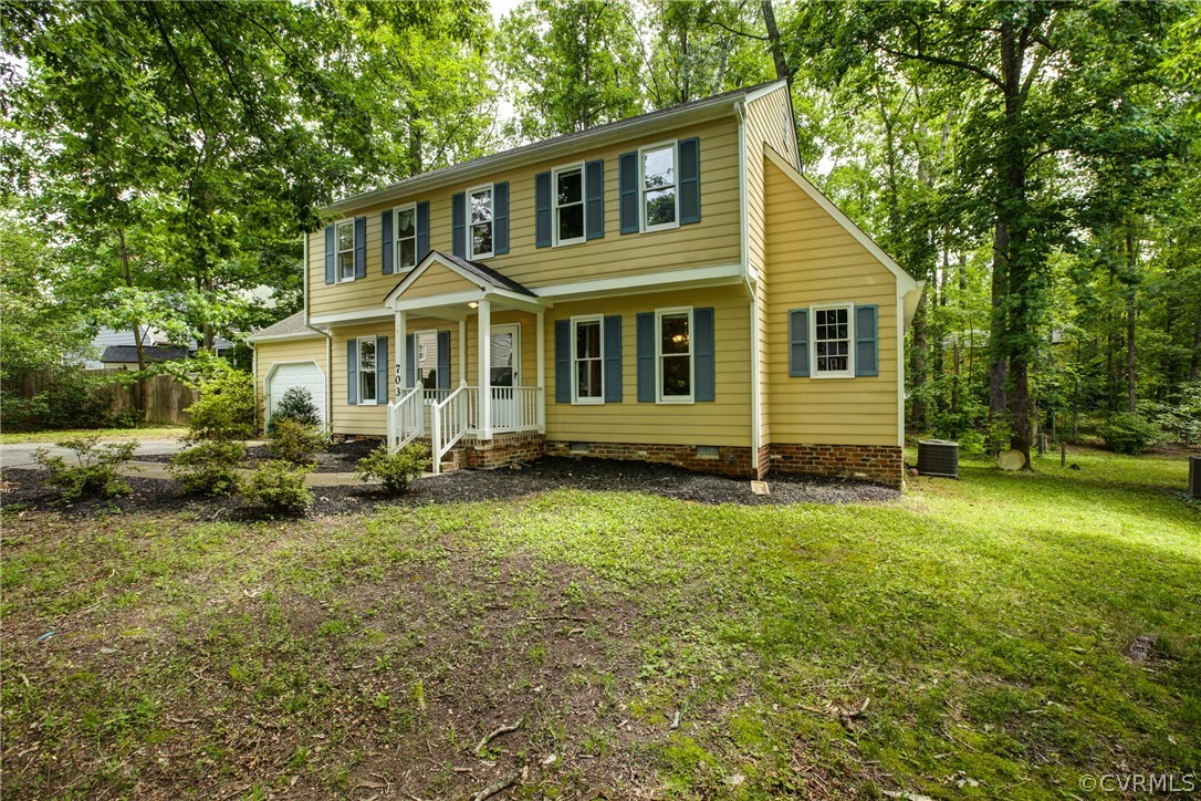 703 Fennimore Road Midlothian, VA 23114 - Photo 2 of 22 a front view of a house with a garden